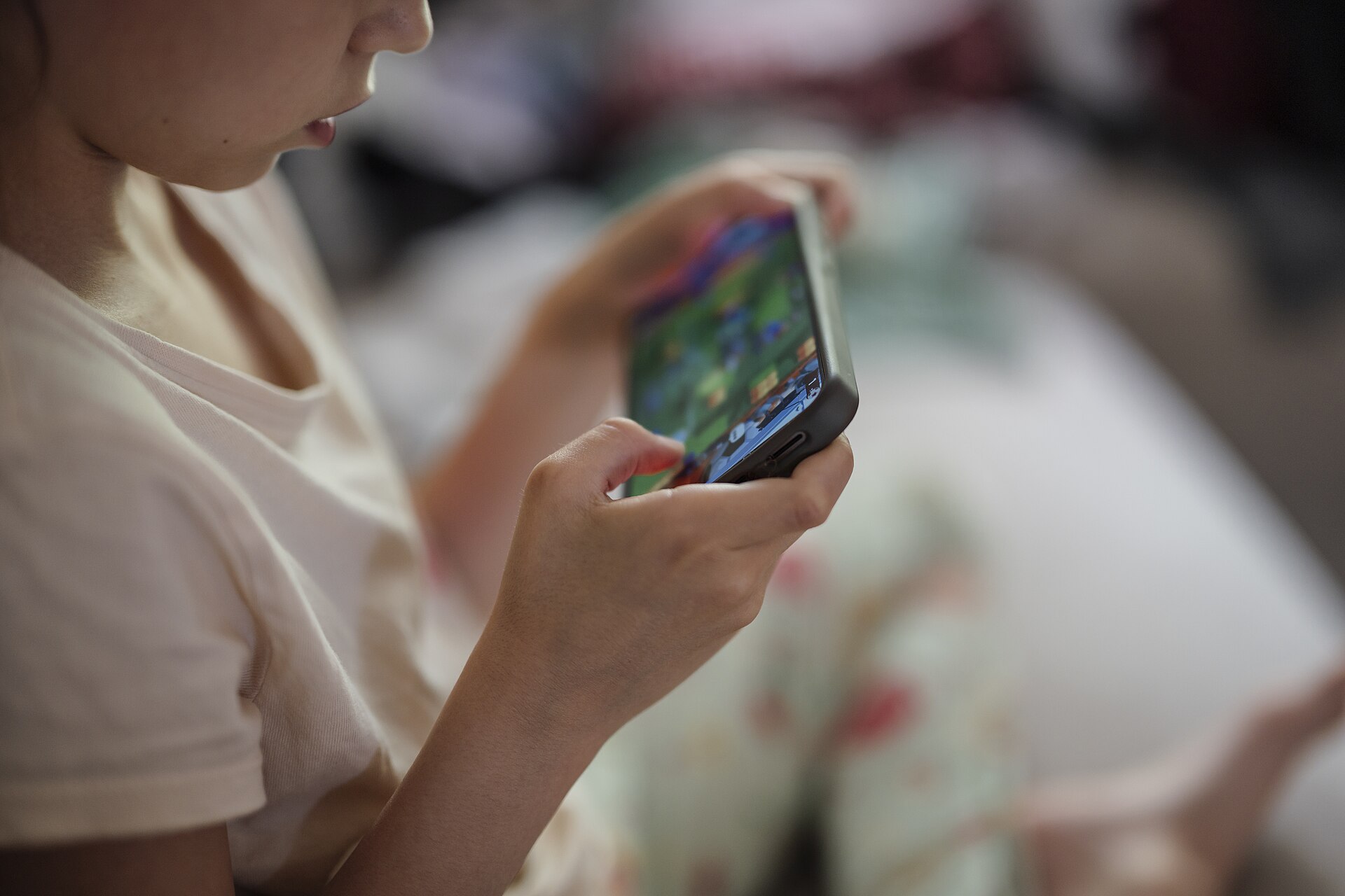A child playing a game on a smartphone